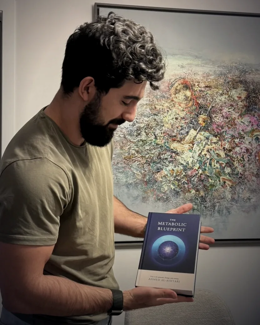 Ahmed Al-Ashtari holding The Metabolic Blueprint